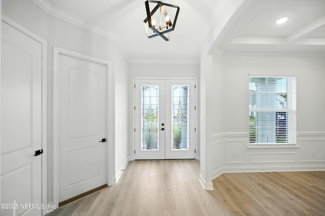 41 Iris Creek Dr, Saint Augustine, FL 32092 - foyer featuring a chandelier, light wood-style flooring, french doors, wainscoting, and ornamental molding