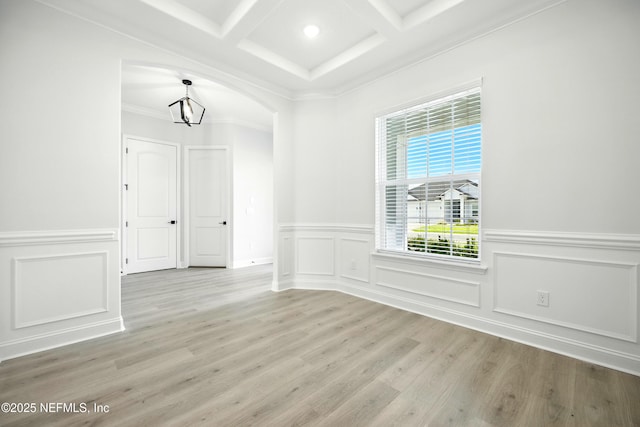 41 Iris Creek Dr, Saint Augustine, FL 32092 - empty room featuring coffered ceiling, beam ceiling, light wood finished floors, a wainscoted wall, and a decorative wall