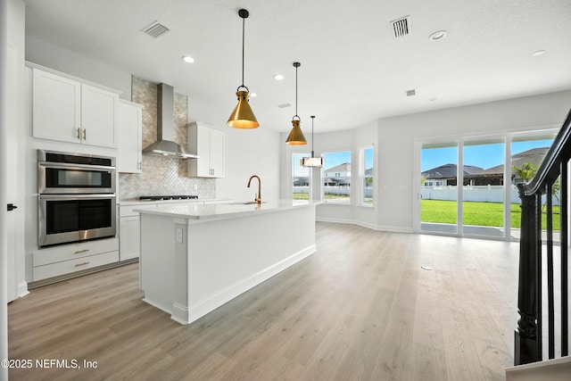 41 Iris Creek Dr, Saint Augustine, FL 32092 - kitchen with wall chimney range hood, double oven, decorative backsplash, recessed lighting, and stovetop