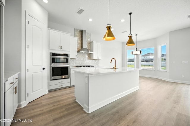 41 Iris Creek Dr, Saint Augustine, FL 32092 - kitchen featuring wall chimney exhaust hood, recessed lighting, light wood finished floors, backsplash, and white cabinetry
