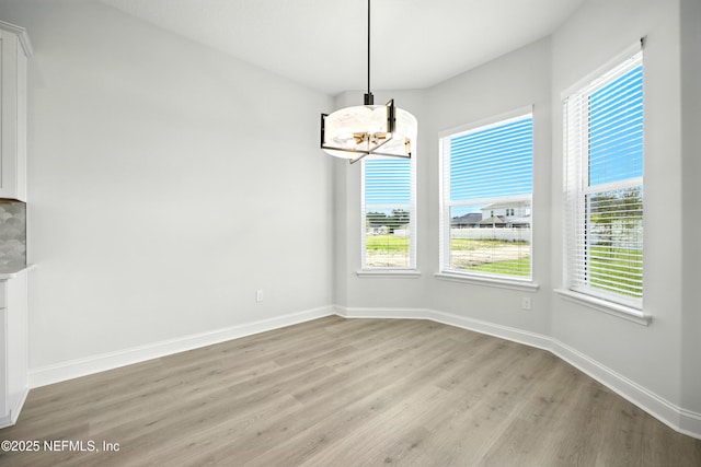 41 Iris Creek Dr, Saint Augustine, FL 32092 - unfurnished dining area featuring a chandelier and light wood finished floors