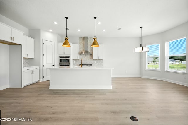41 Iris Creek Dr, Saint Augustine, FL 32092 - kitchen featuring wall chimney range hood, recessed lighting, decorative backsplash, double oven, and white cabinetry