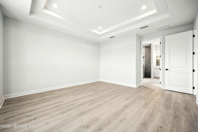 41 Iris Creek Dr, Saint Augustine, FL 32092 - empty room with a tray ceiling, recessed lighting, and light wood-type flooring