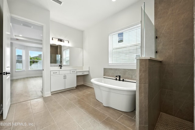 41 Iris Creek Dr, Saint Augustine, FL 32092 - full bathroom featuring vanity, a soaking tub, walk in shower, and tile patterned floors