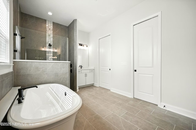 41 Iris Creek Dr, Saint Augustine, FL 32092 - bathroom with a walk in shower, a freestanding tub, vanity, recessed lighting, and tile patterned flooring