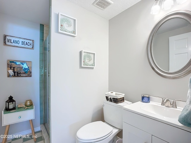 full bathroom featuring visible vents, vanity, toilet, and tiled shower