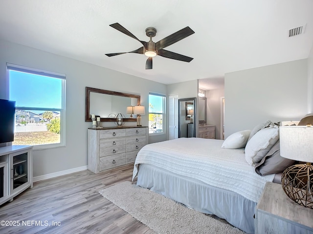 bedroom featuring baseboards, ceiling fan, visible vents, and light wood-style floors