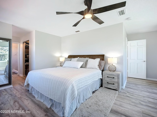 bedroom with light wood-style floors, baseboards, and visible vents