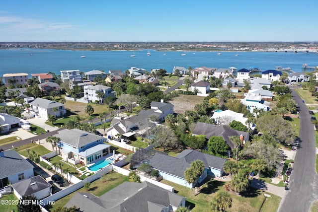 drone / aerial view with a water view and a residential view