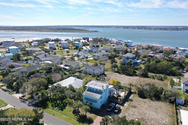 drone / aerial view featuring a residential view and a water view