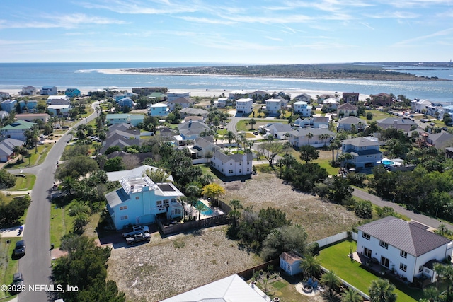 drone / aerial view with a water view and a residential view