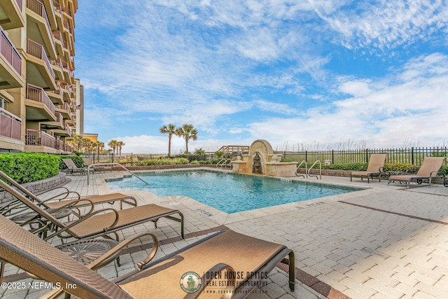 pool featuring a patio area and fence