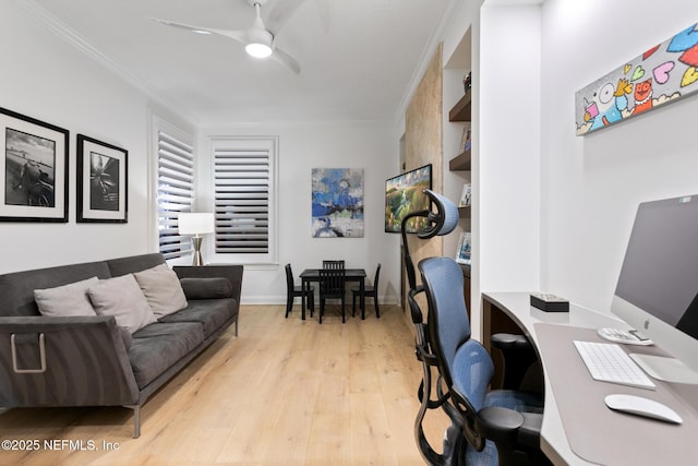 office area featuring ornamental molding, ceiling fan, light wood-style flooring, and baseboards