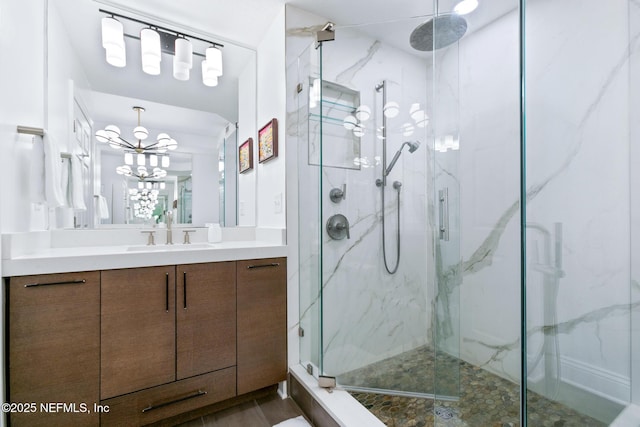 full bath with a marble finish shower and vanity