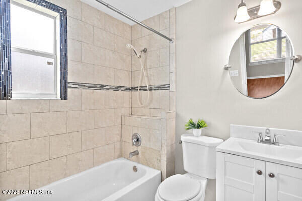 full bath featuring toilet,  shower combination, and vanity