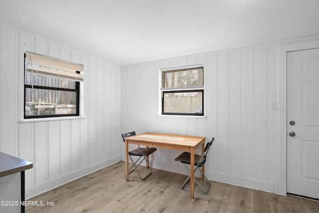 office area with light wood-style floors and baseboards