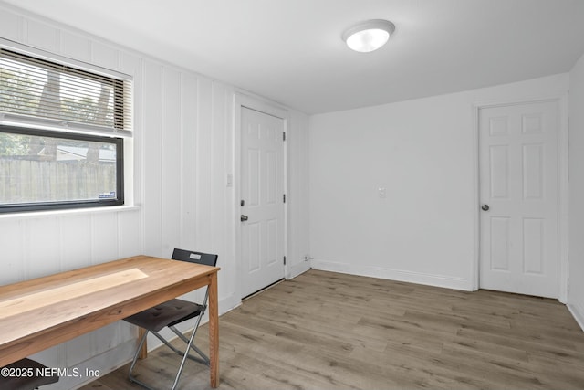 office area featuring baseboards and light wood finished floors