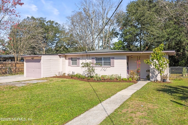 ranch-style home with an attached garage, driveway, fence, and a front lawn