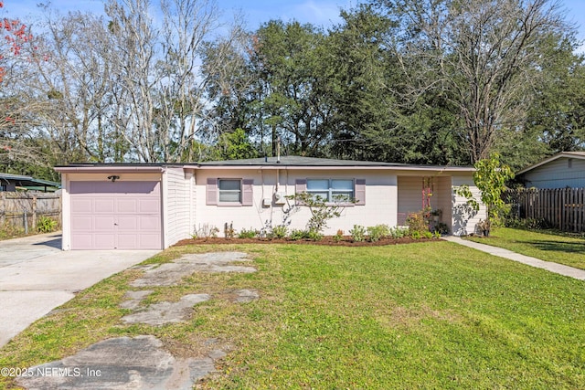 ranch-style home with a garage, driveway, concrete block siding, fence, and a front lawn