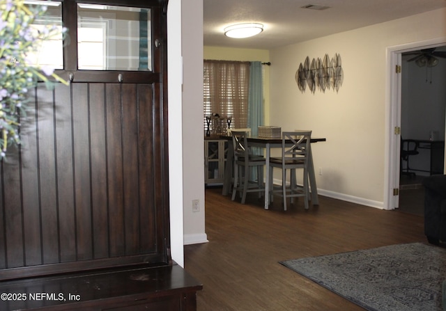 dining area with baseboards and wood finished floors