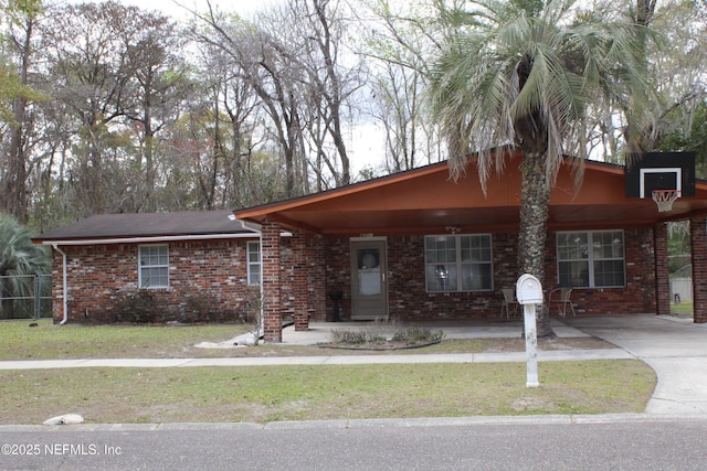 ranch-style home with brick siding and a front yard