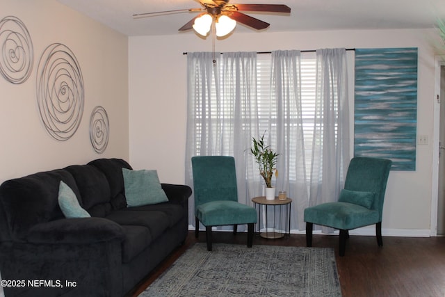 living room with baseboards, a ceiling fan, and wood finished floors