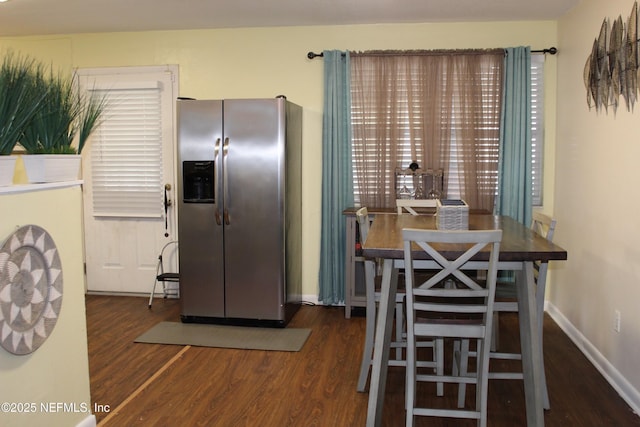 dining space with baseboards and wood finished floors