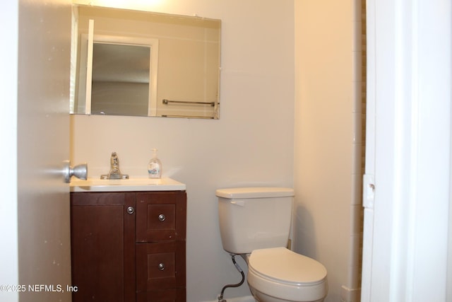 half bathroom with toilet and vanity