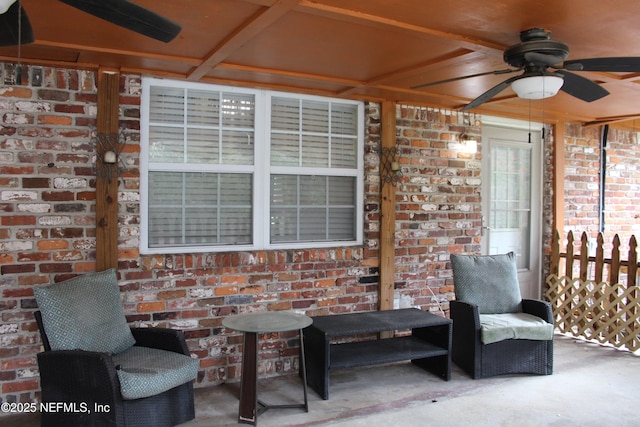 view of patio featuring a ceiling fan and fence