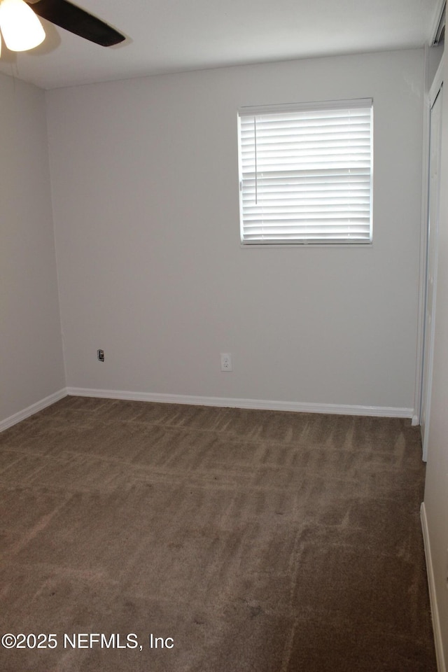 empty room with baseboards, carpet floors, and a ceiling fan