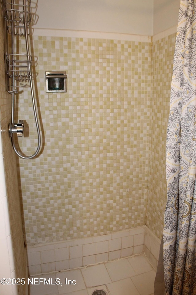 bathroom with a tile shower