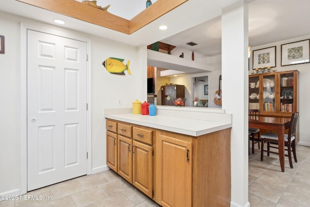 kitchen with baseboards, light countertops, and recessed lighting