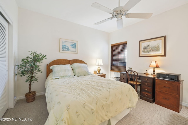 bedroom with light carpet, ceiling fan, and baseboards