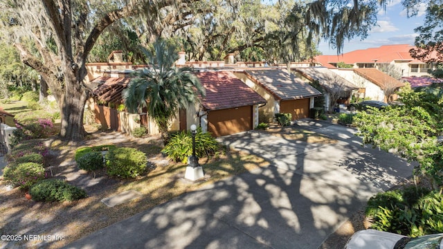 view of front of property with a garage and a tile roof