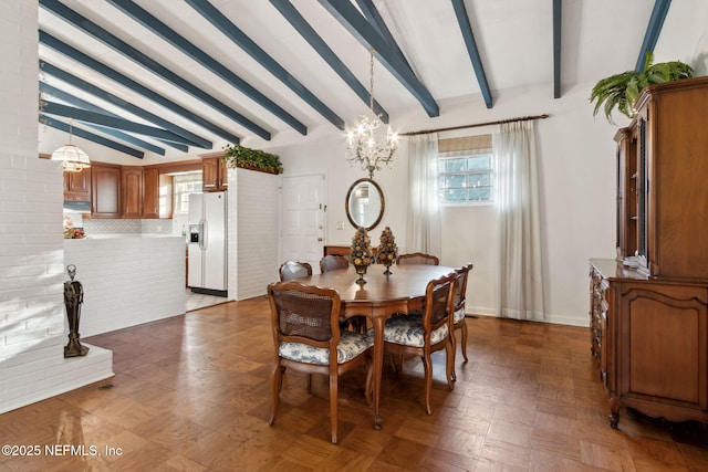 dining area featuring lofted ceiling with beams and an inviting chandelier