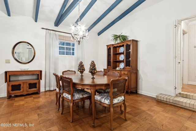 dining space with a chandelier, lofted ceiling with beams, and baseboards