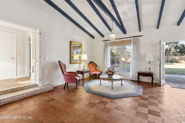 living area with high vaulted ceiling, beam ceiling, and baseboards