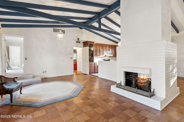 living area featuring high vaulted ceiling, a brick fireplace, visible vents, and beam ceiling