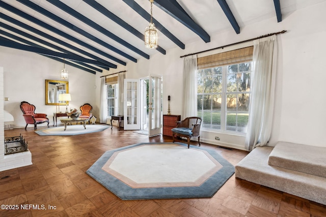 living area featuring a chandelier, visible vents, lofted ceiling with beams, and baseboards