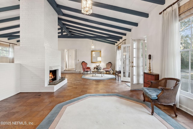 interior space with high vaulted ceiling, french doors, a fireplace, and beam ceiling