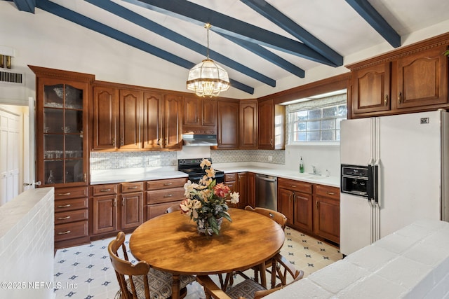 kitchen with vaulted ceiling with beams, under cabinet range hood, visible vents, dishwasher, and white fridge with ice dispenser