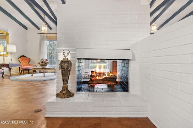 room details with beamed ceiling and a multi sided fireplace