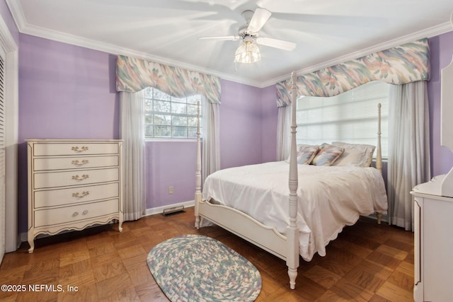 bedroom with baseboards, ornamental molding, and a ceiling fan