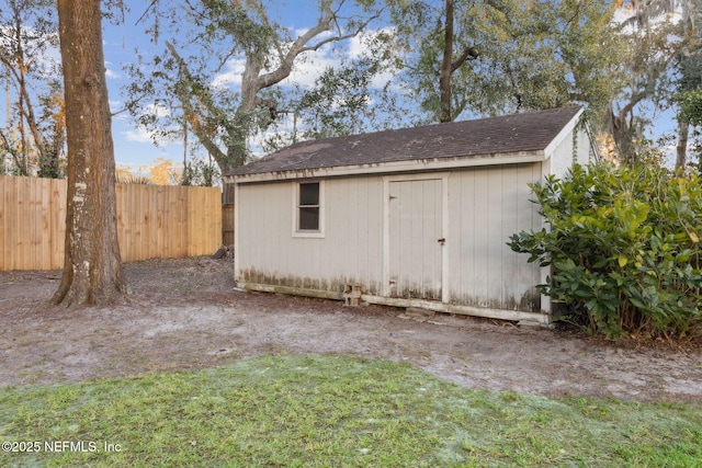 view of shed featuring fence