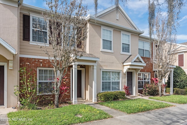 multi unit property with stucco siding and brick siding