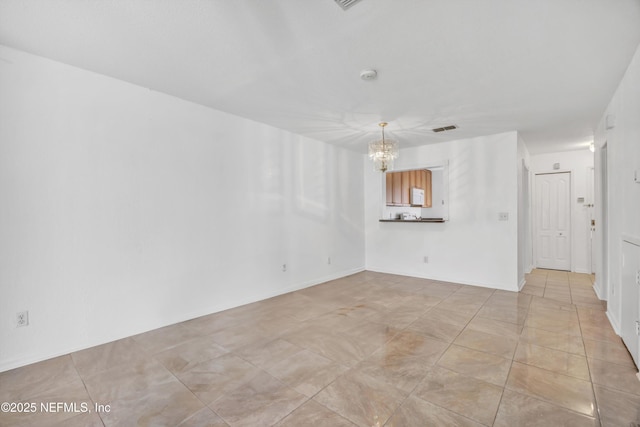 interior space featuring visible vents, a notable chandelier, and light tile patterned flooring