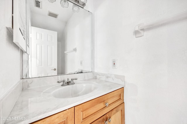 bathroom with visible vents and vanity