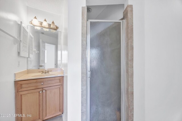 bathroom featuring vanity and a stall shower