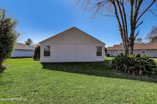 view of side of home featuring a yard