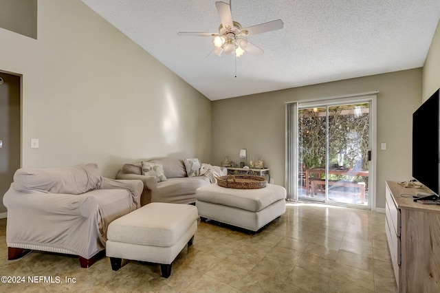 living room with lofted ceiling, light tile patterned floors, a textured ceiling, and a ceiling fan